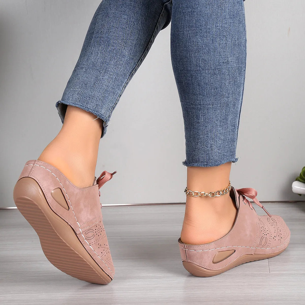 Women's black lace-up wedge slippers with suede upper and hollow-out design on a rubber sole.