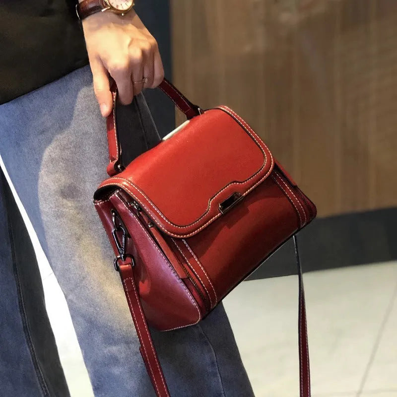 Genuine leather women's retro messenger bag in brown, showing internal organiser pockets and shoulder strap.