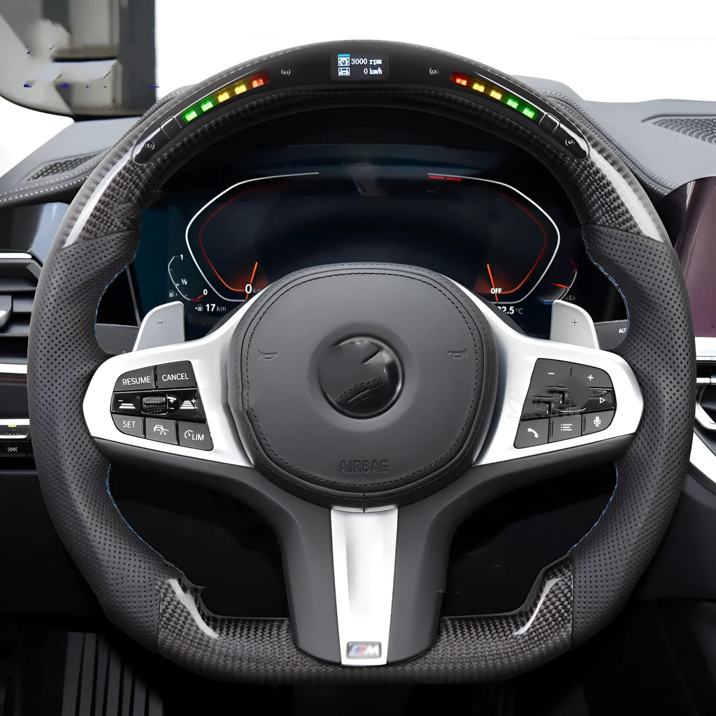 Black carbon fibre BMW sports steering wheel with integrated LED multifunctional display.