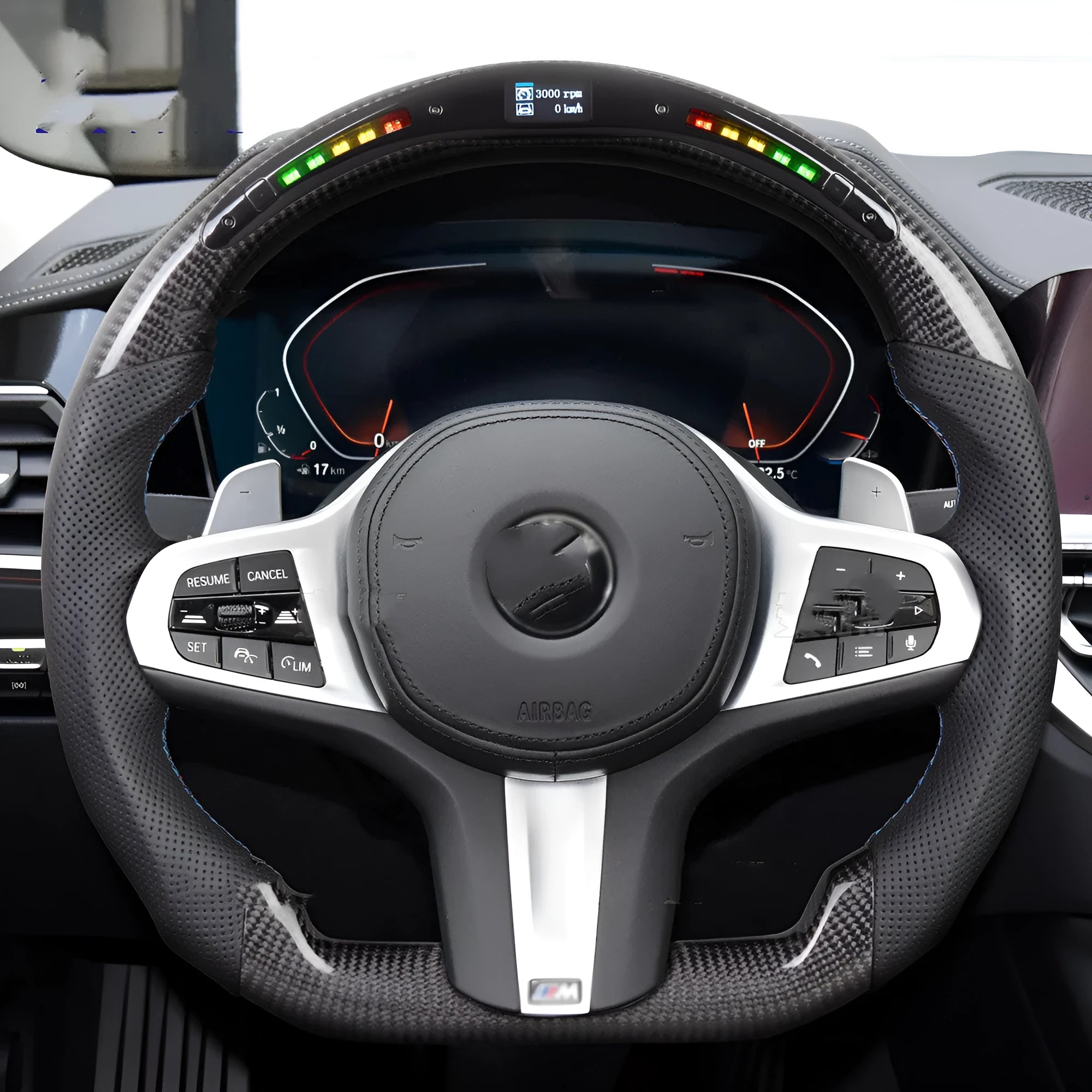Black carbon fibre BMW sports steering wheel with integrated LED multifunctional display.