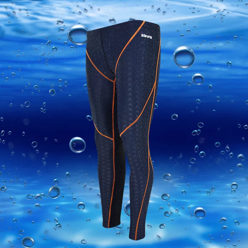 Men's black and grey line nylon cropped swimming trunks laid flat.