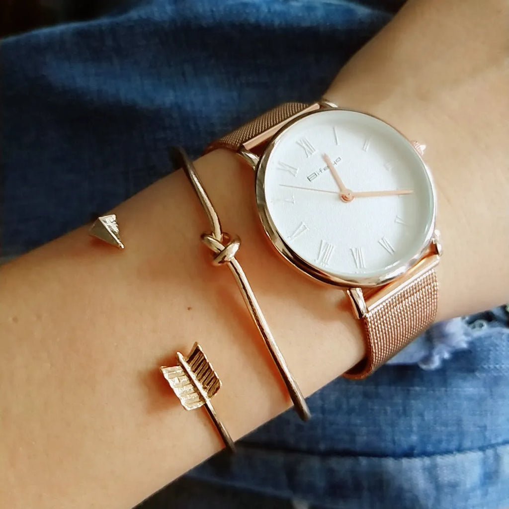 Gold electroplated alloy women's cuff bracelet with arrow and knotted design pattern