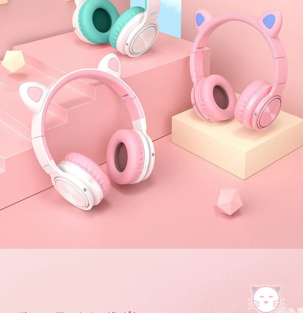 Pink white Luminous Bluetooth over-ear headphones showing protein ear cushions and braided cable.