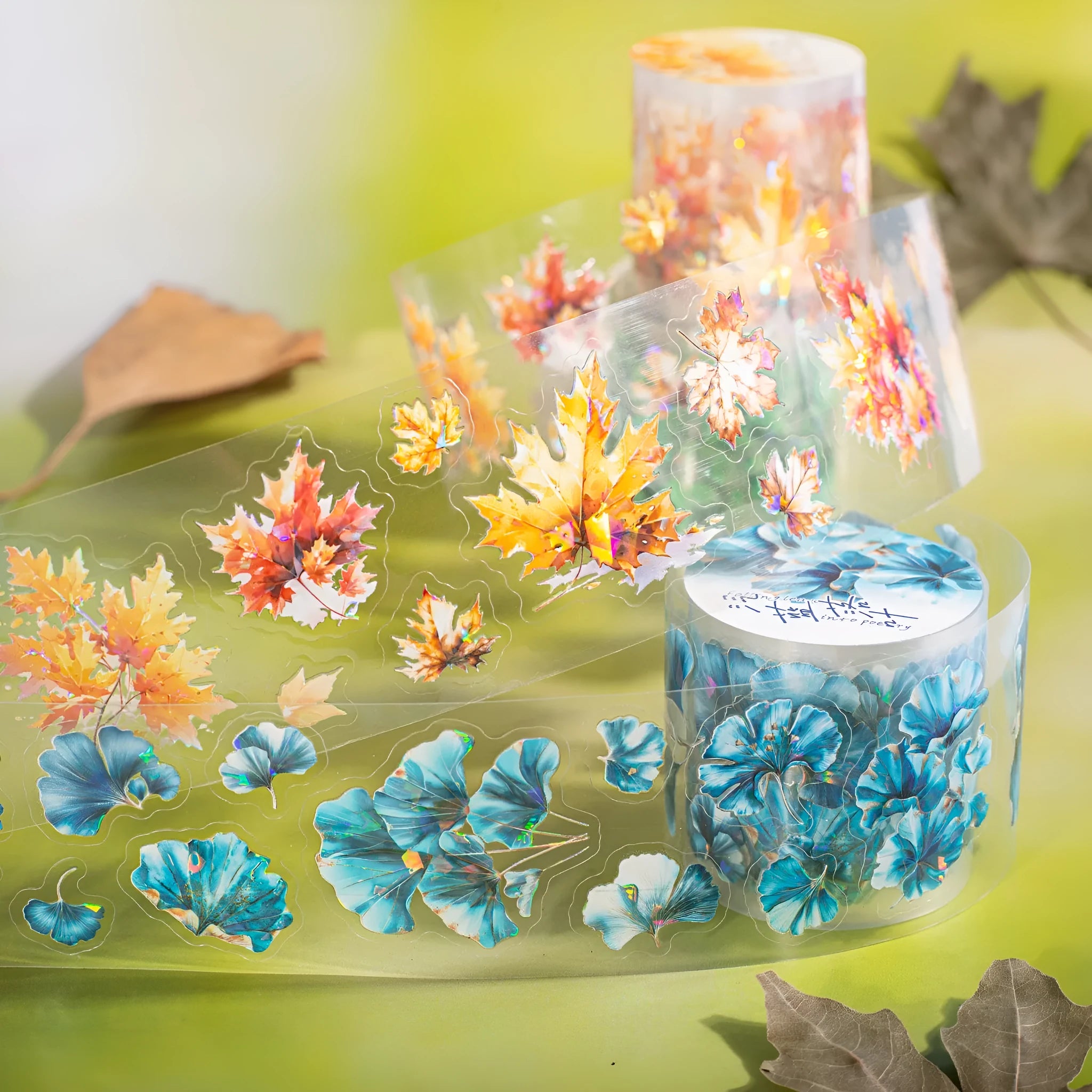 Roll of nature-themed decorative stickers showing ginkgo leaves, maple leaves, and blue fallen leaves designs