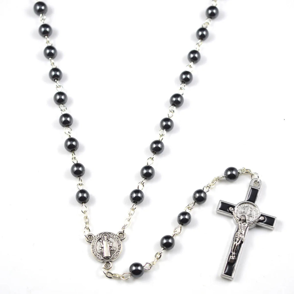Black rosary necklace with hematite beads and zinc alloy cross on plain background