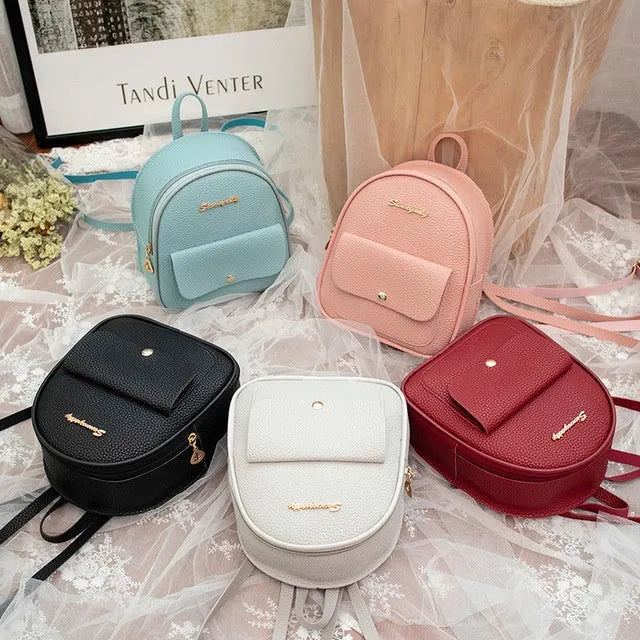 Small black PU women's backpack with shoulder strap showing compact dimensions