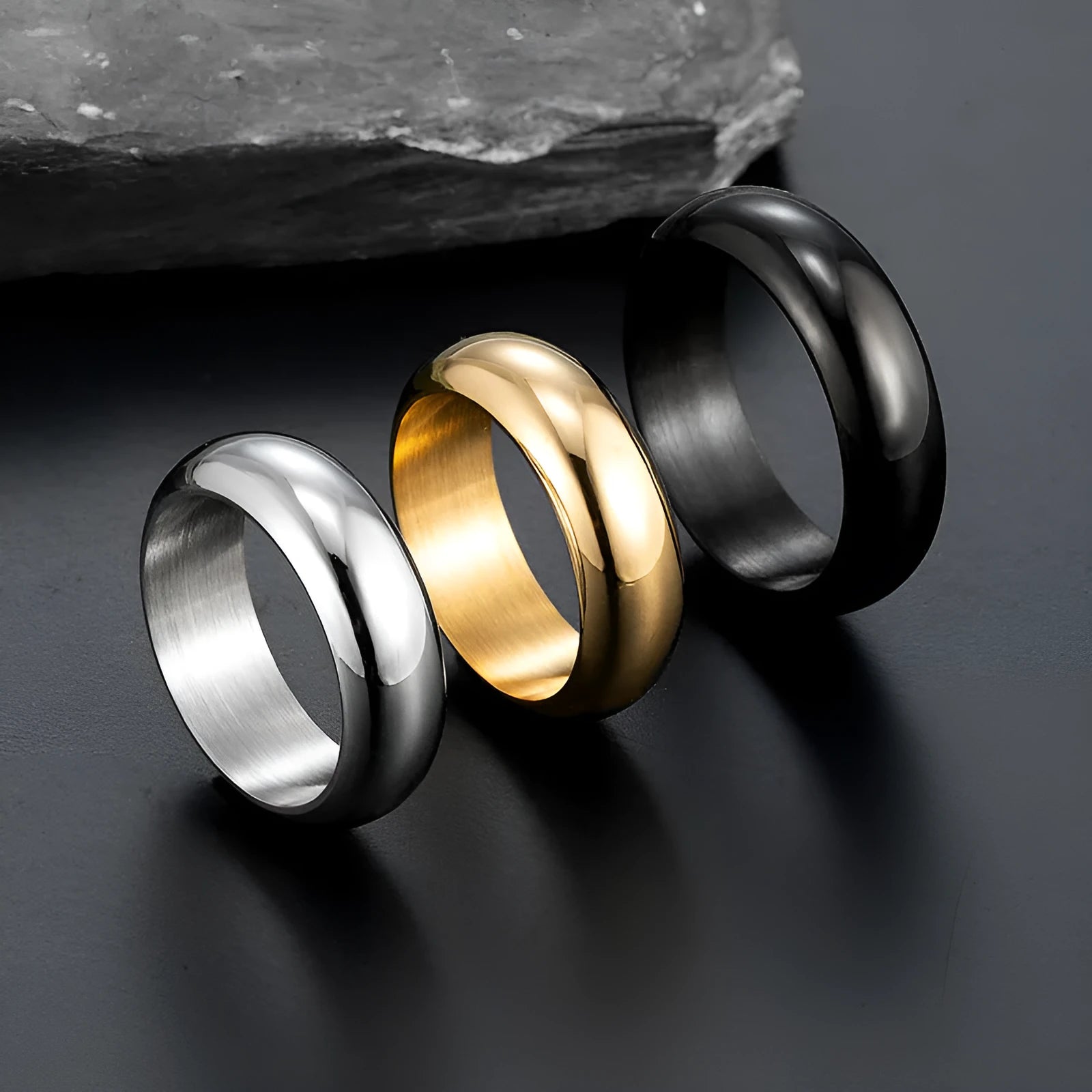 Glossy electroplated titanium steel ring in gold, black and steel colours showing detailed finish