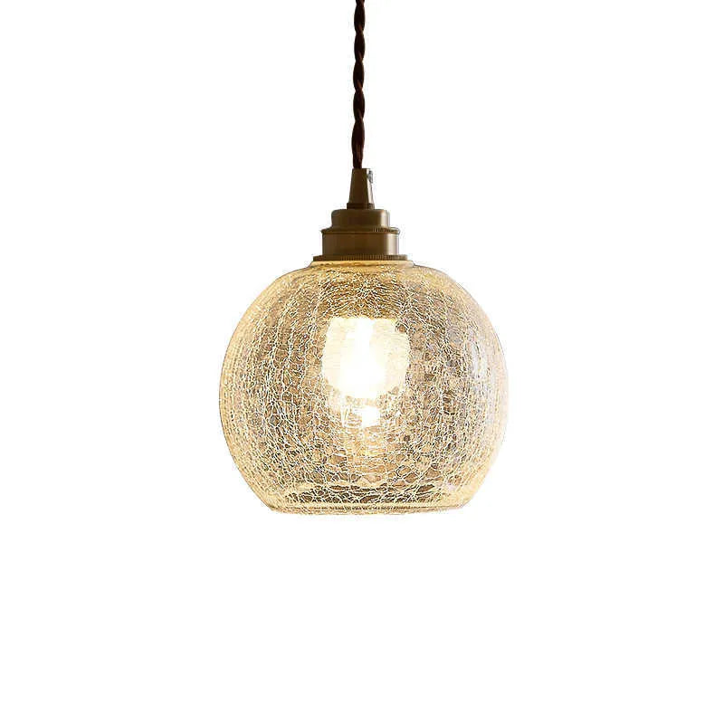 Retro brass and glass ball chandelier ceiling light with copper frame and spherical shade.