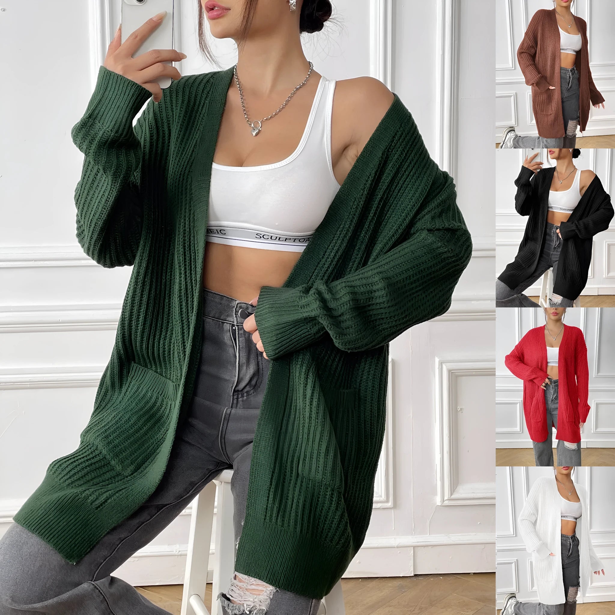 Womans loose fit acrylic cardigan sweater in dark green, showing mid-length and long sleeves.
