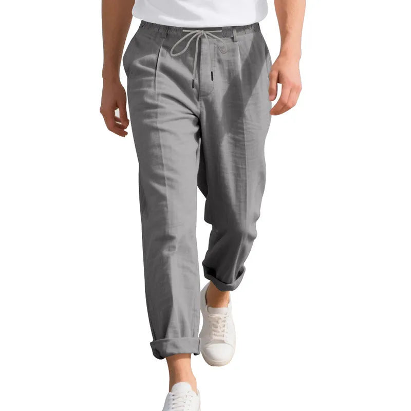 Men's light khaki linen casual trousers with a loose straight-leg fit and drawstring waist.