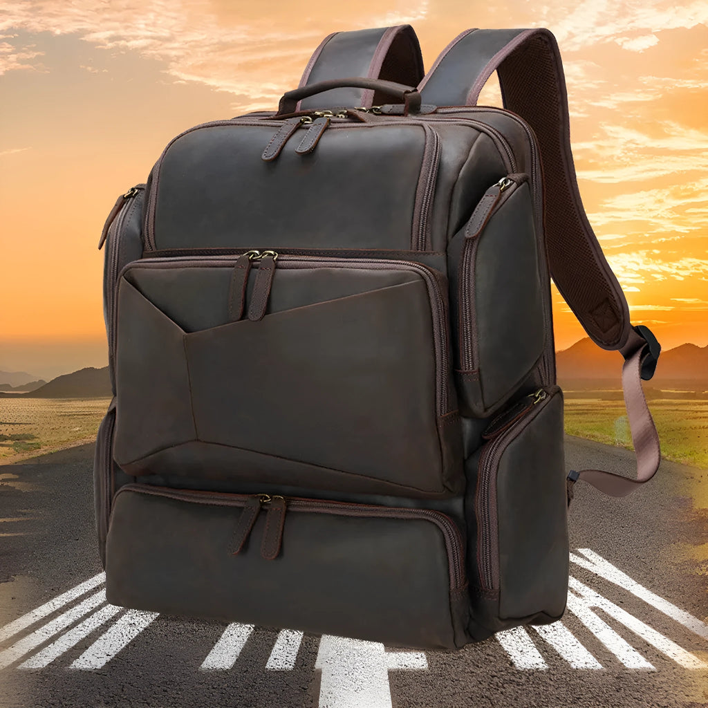 Dark brown genuine leather 17-inch laptop backpack with double straps and multiple pockets.