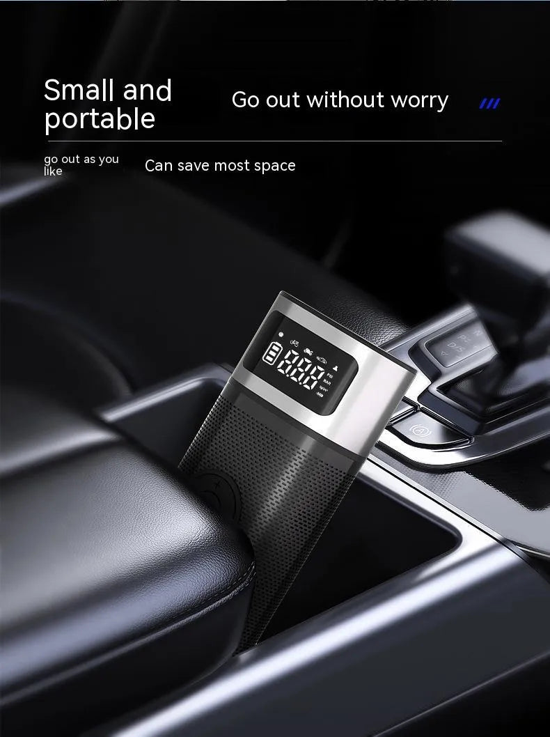 Black portable wireless smart vehicle air pump with a display, inflation tube, and multiple nozzles on a dark background.