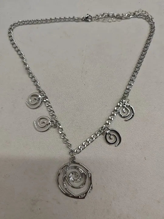 Spiral donut jewellery set with necklace, bracelet and earrings showing geometric circle designs in gold and silver finishes
