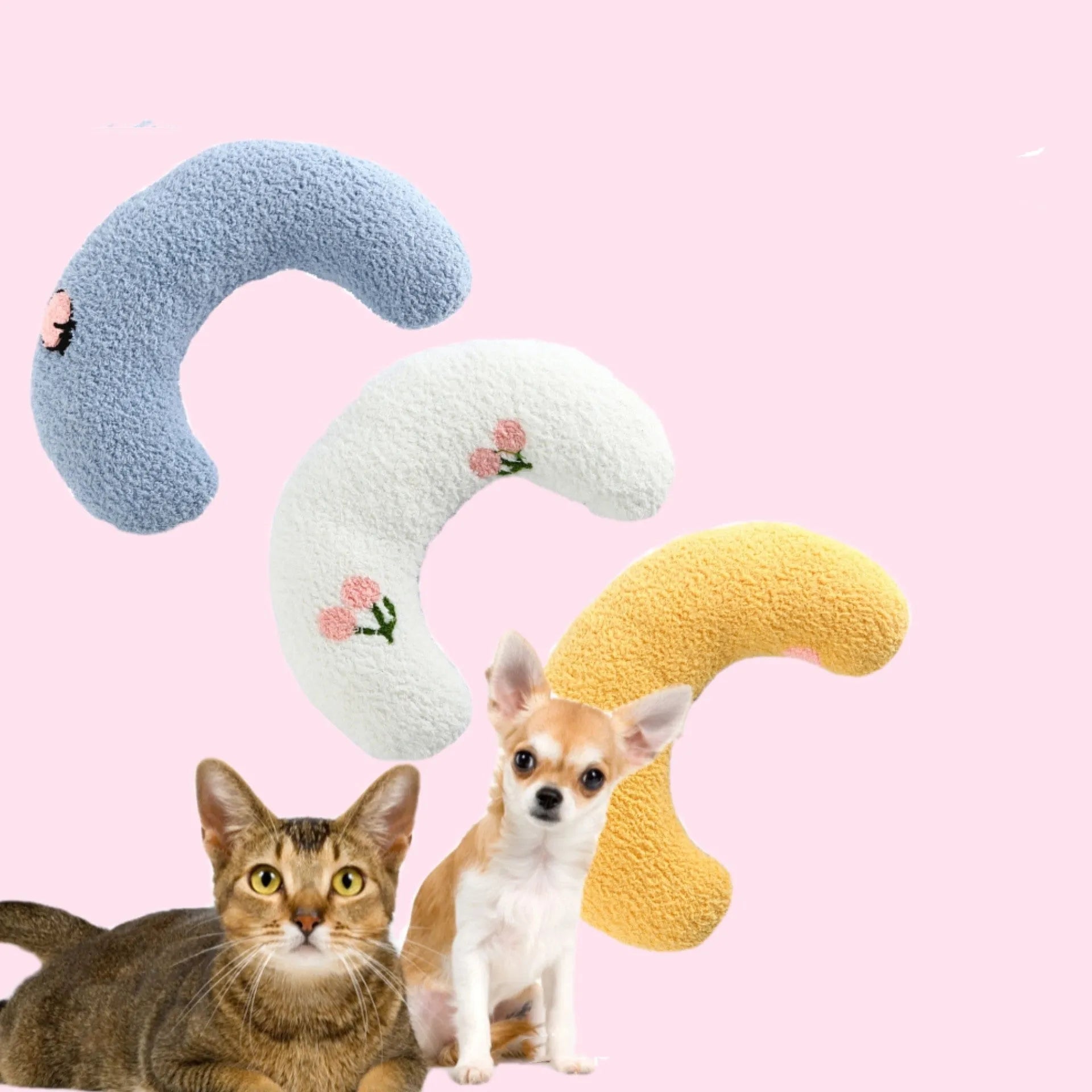 Small white blue yellow U-shaped plush pillow for cats and small dogs on a bed.