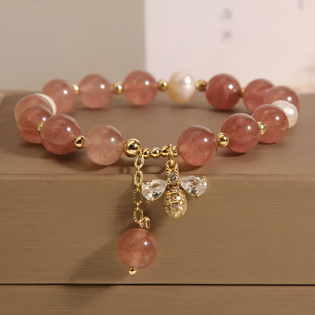 Women's freshwater pearl and strawberry quartz bracelet with zircon accents on wrist