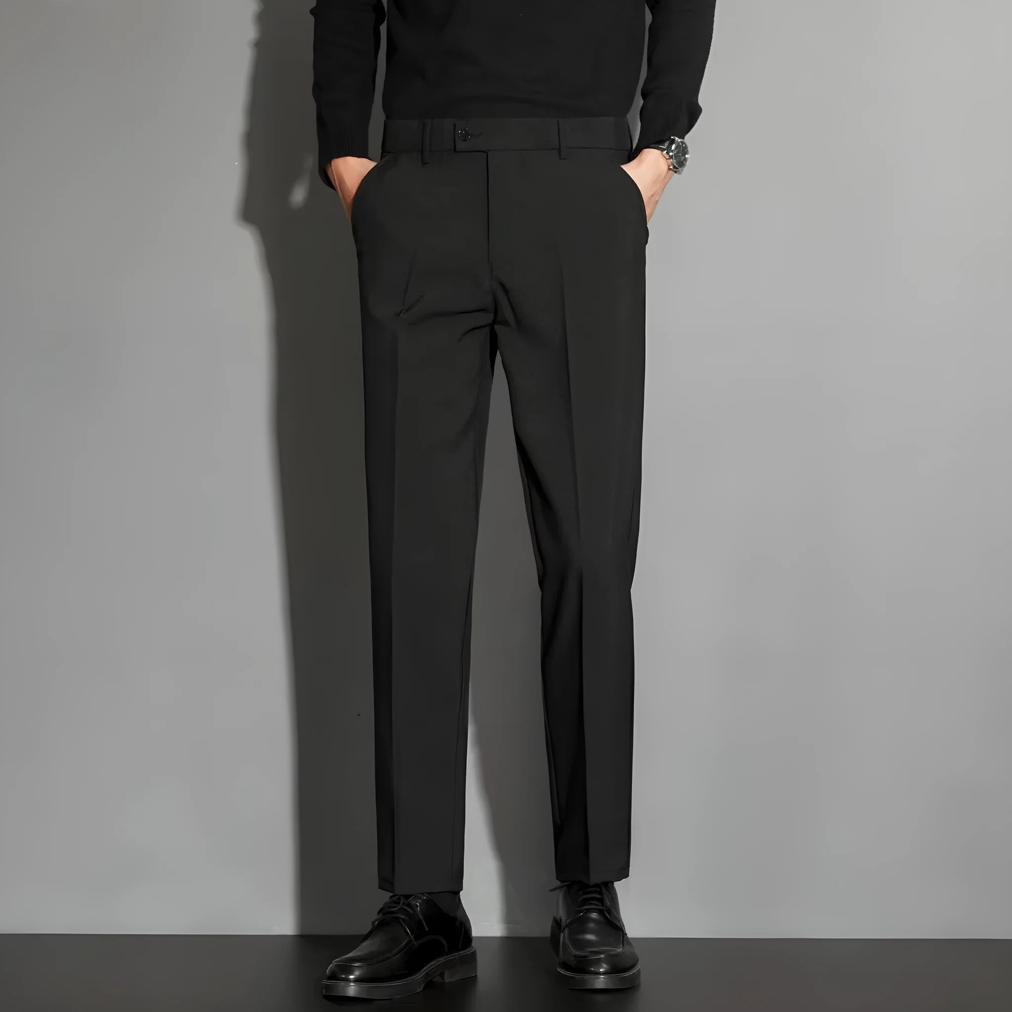 Men's straight-leg ankle-length suit trousers in a chemical fibre blend fabric shown in a classic colour.