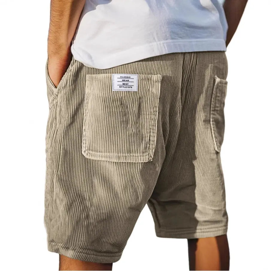 Men's gray corduroy shorts with multiple pockets showing straight leg cut and textured fabric