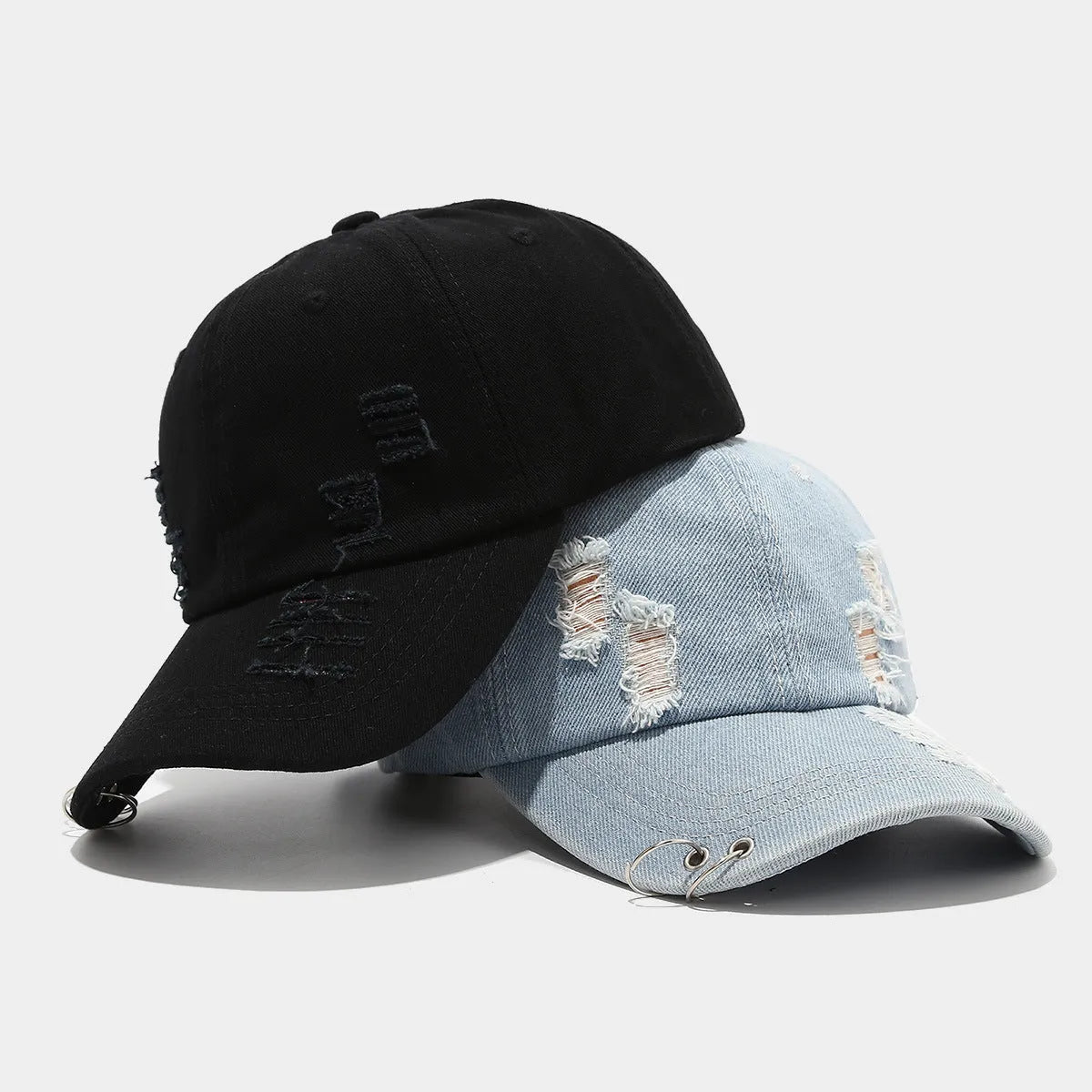 Men's black denim peaked cap with adjustable strap and dome crown on a plain background.