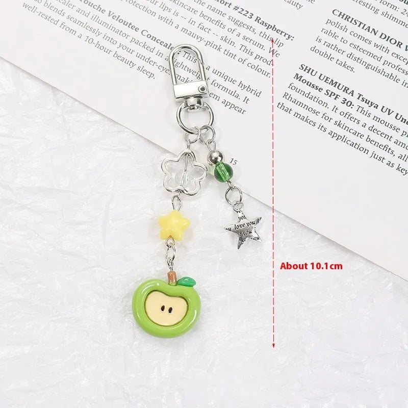 Coloured plastic fruit phone charms with rope attachments including apple and strawberry designs