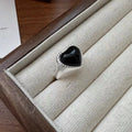 Adjustable sterling silver ring with heart-shaped black agate centrepiece showing open mouth design