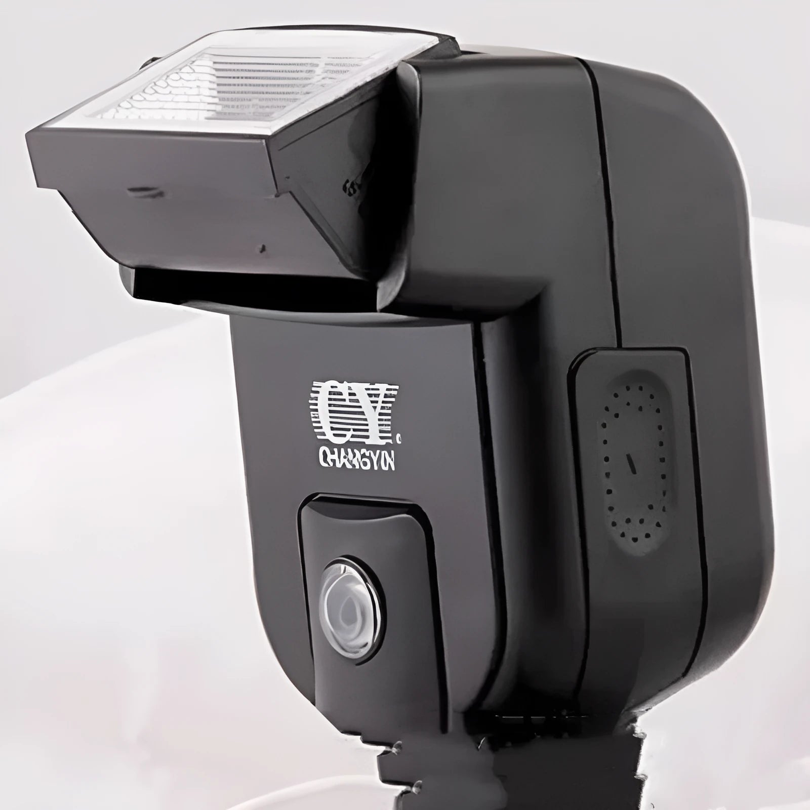 Silver hot shoe flash unit tilted on SLR camera showing aluminium construction and compact 65x60x98mm dimensions