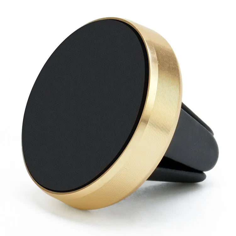 Magnetic car phone holder in rose gold attached to a car air vent