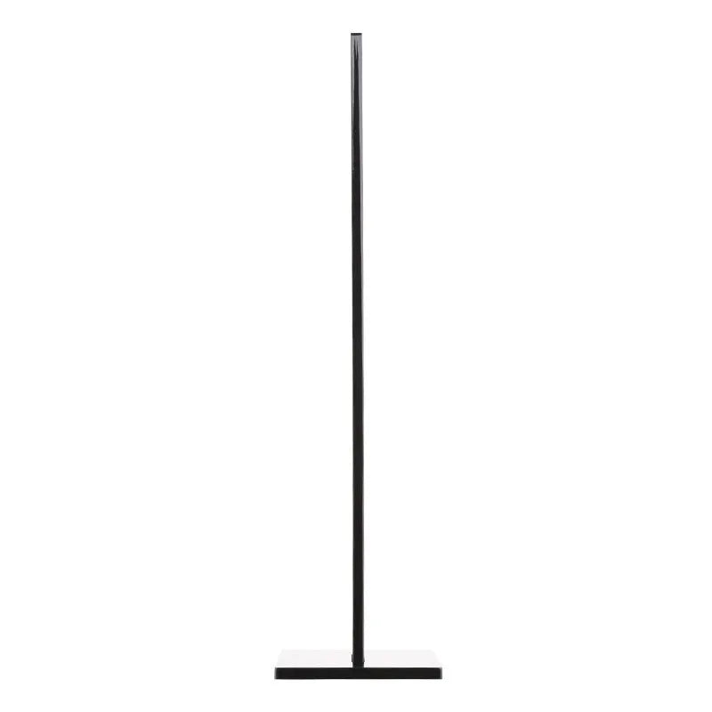 Black detachable head-mounted gaming headset stand with a silicone base on a wooden desk.