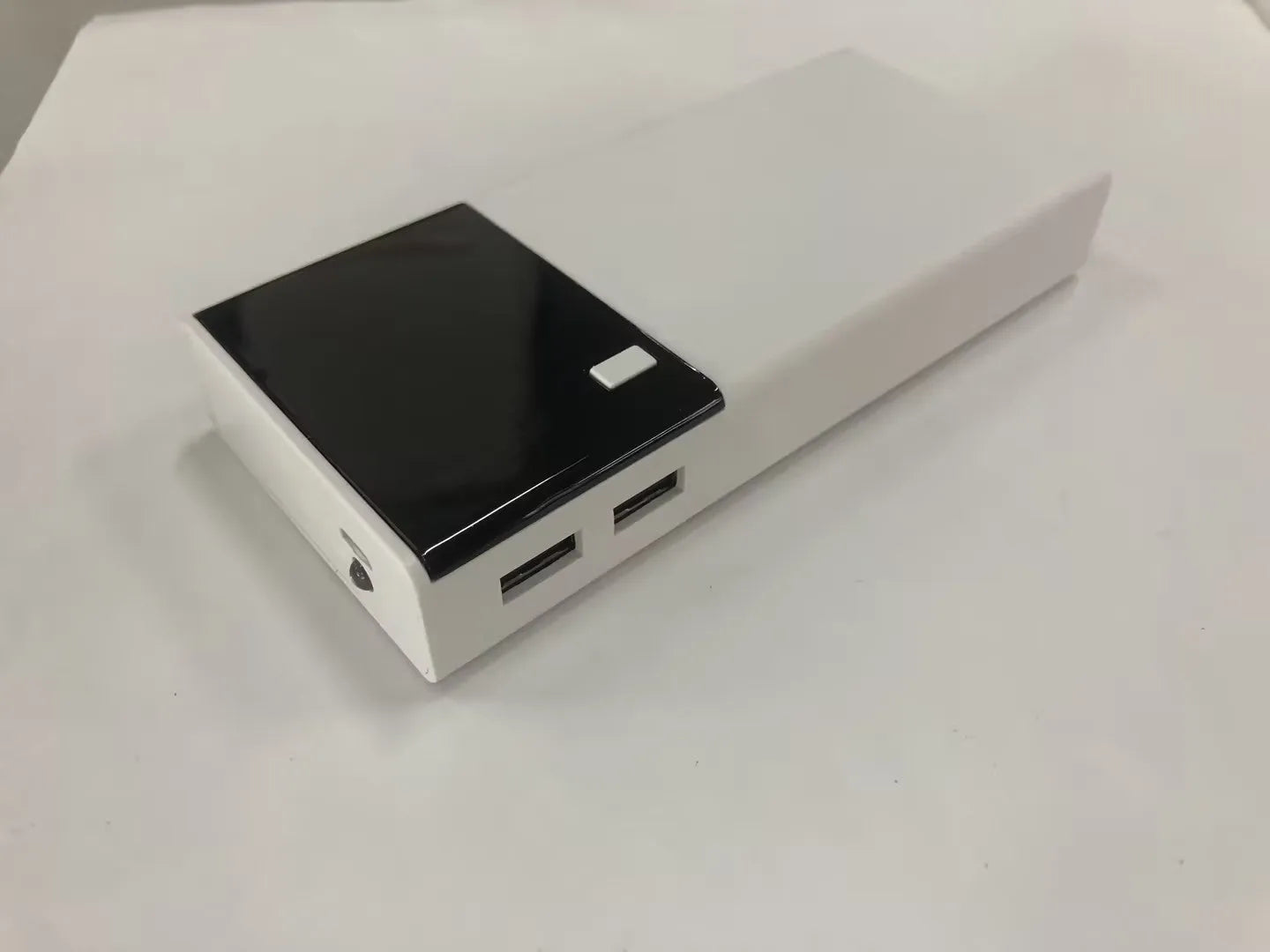 Black 20000mAh portable power bank with included USB charging cable