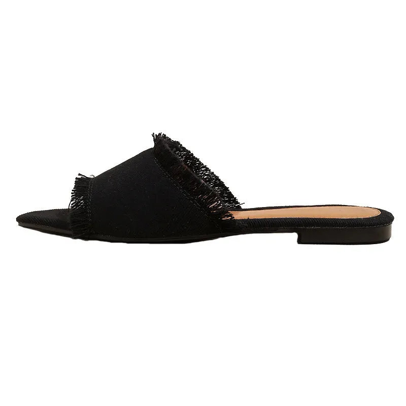 Women's flat denim slippers with a tassel detail, shown in apricot colour.