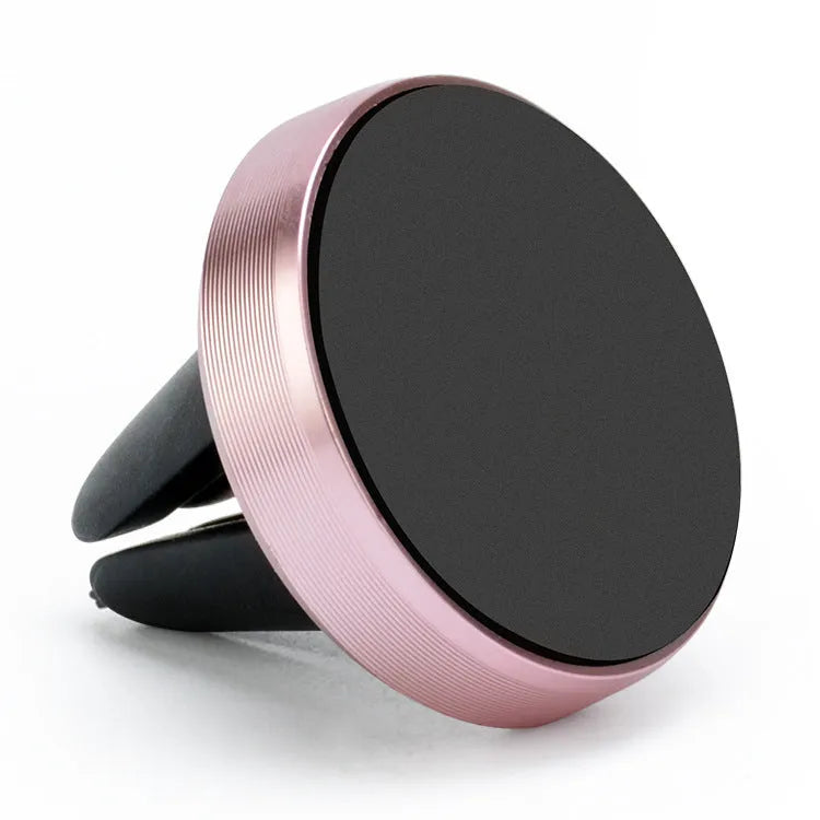 Magnetic car phone holder in rose gold attached to a car air vent