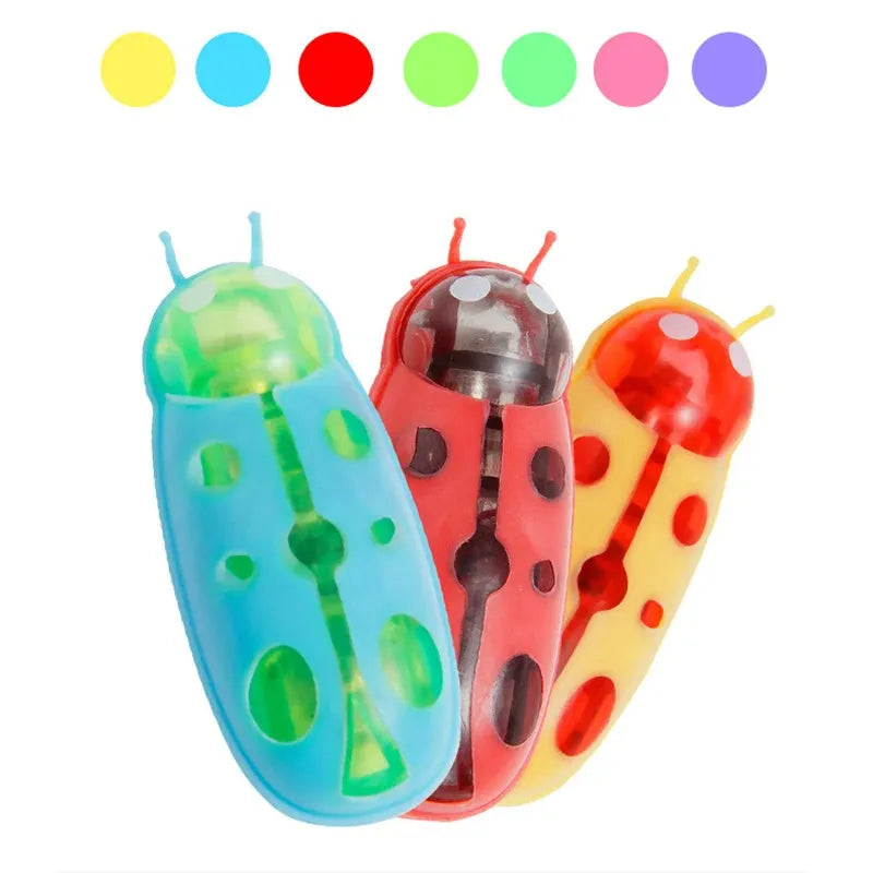 Small electric ladybird beetle cat toy with 12 walking legs on grey surface