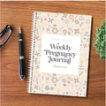 A5 Pregnancy Weekly Diary Notebook open on a page, showing weekly tracking sections.