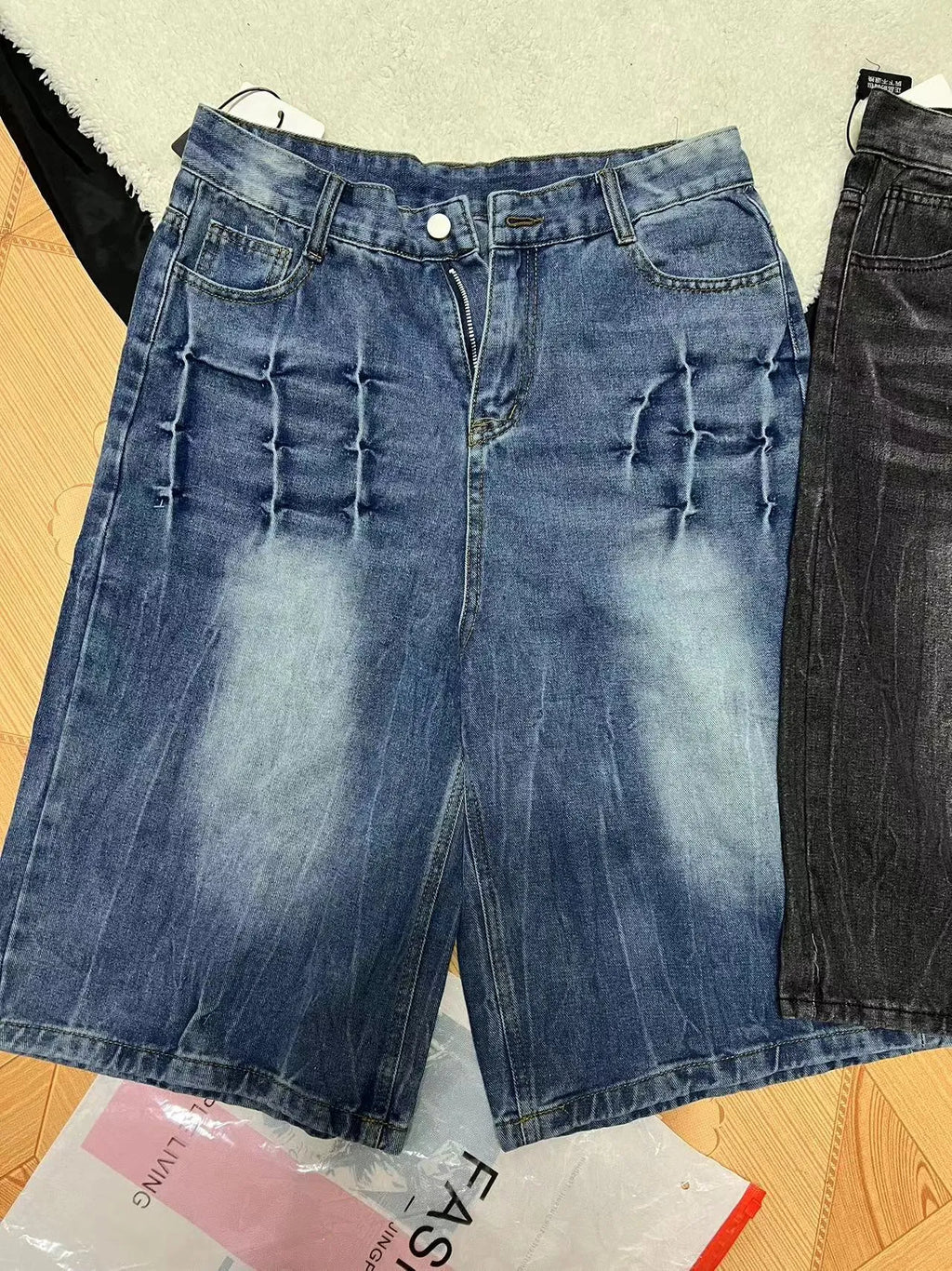 Men’s loose straight-leg washed denim shorts in blue side view