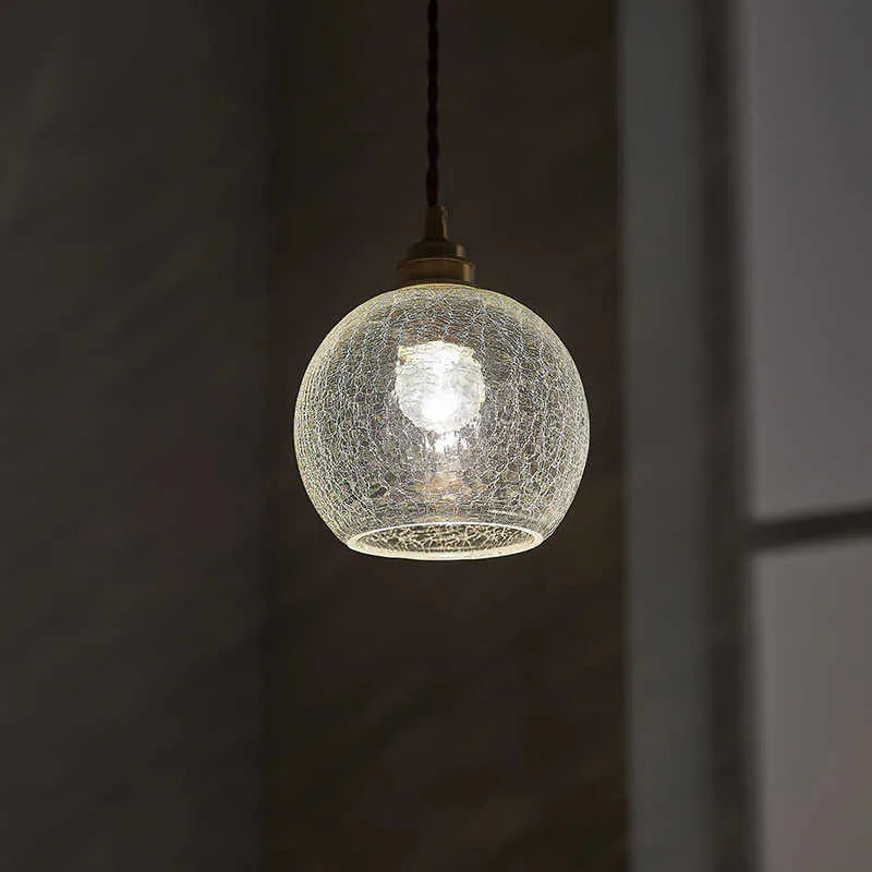 Retro brass and glass ball chandelier ceiling light with copper frame and spherical shade.
