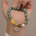 Women's fashion bracelet made from natural green jade shells on a casual background