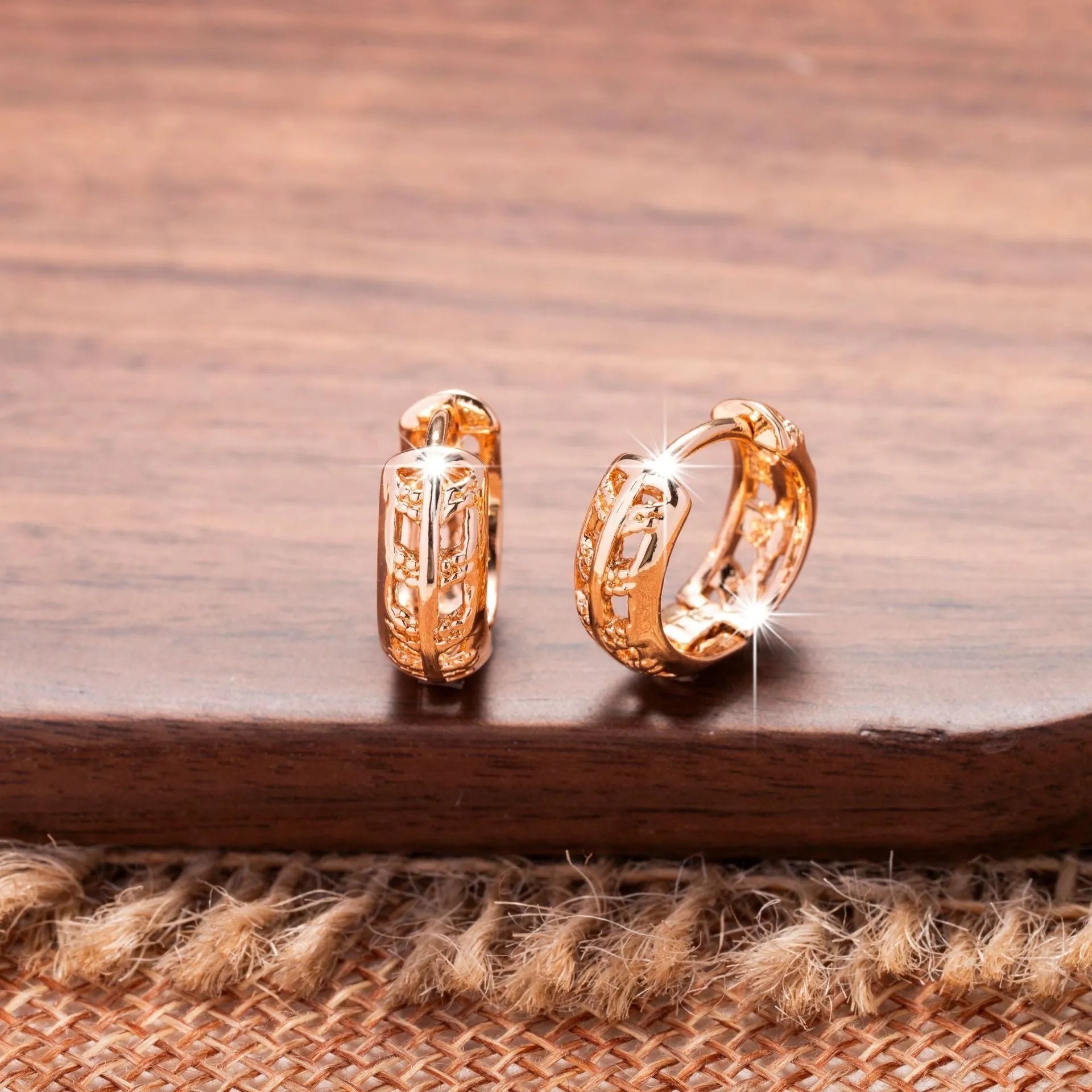 Rose gold finished leaf-shaped hollowed-out earrings with heart detail on copper base