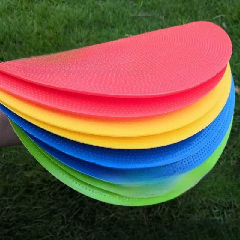 Soft yellow TPE football training disc on grass, showing 23cm diameter flat marker.