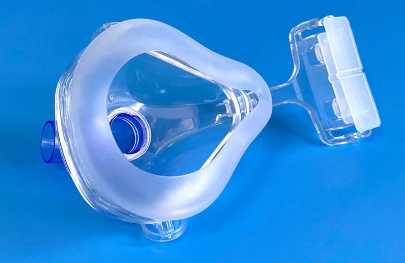 Transparent CPAP breathing mask with silicone cushion and two elbow adapters for ventilator connection