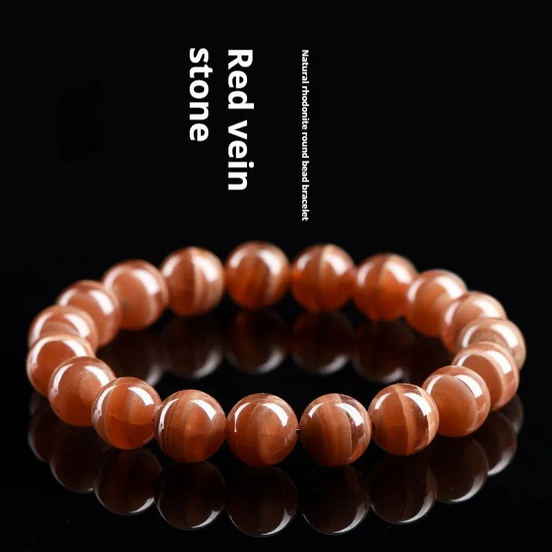Natural old mine rhodochrosite round bead bracelet with Ruyi charm, Peruvian mineral jewellery.