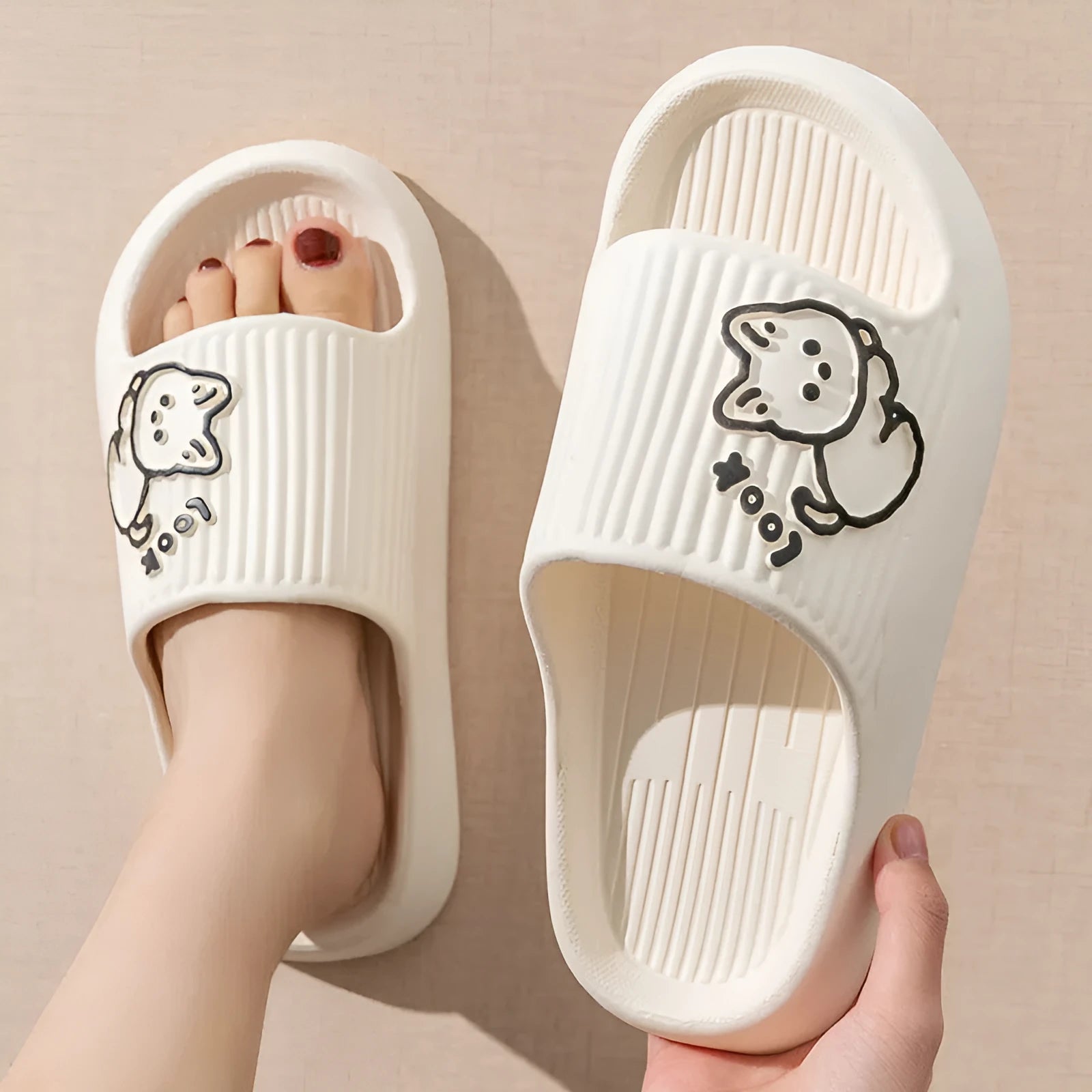 Women's cat platform slippers in pink with thick EVA sole, shown on a wooden floor.