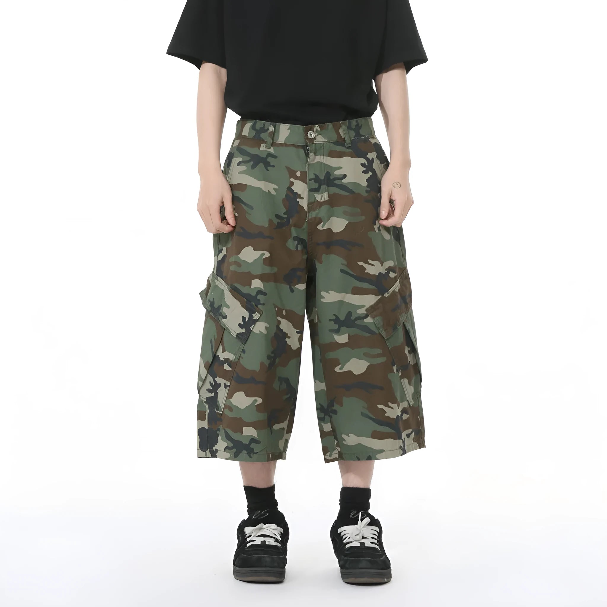 Men's green camouflage cotton trousers with wide loose legs, large side pockets, and cropped length