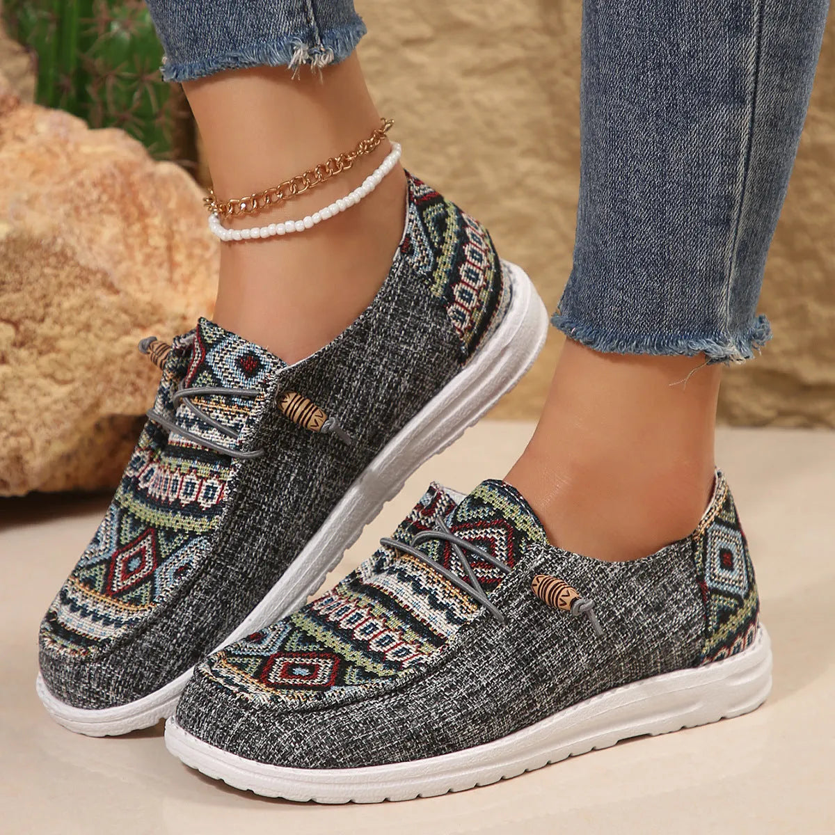 Women's low-top flat slip-on shoes in black with a round toe and rubber sole.