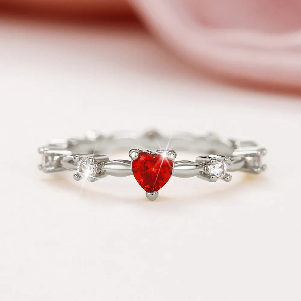 Gold electroplated copper ring with a peach heart charm and set zircon stone.