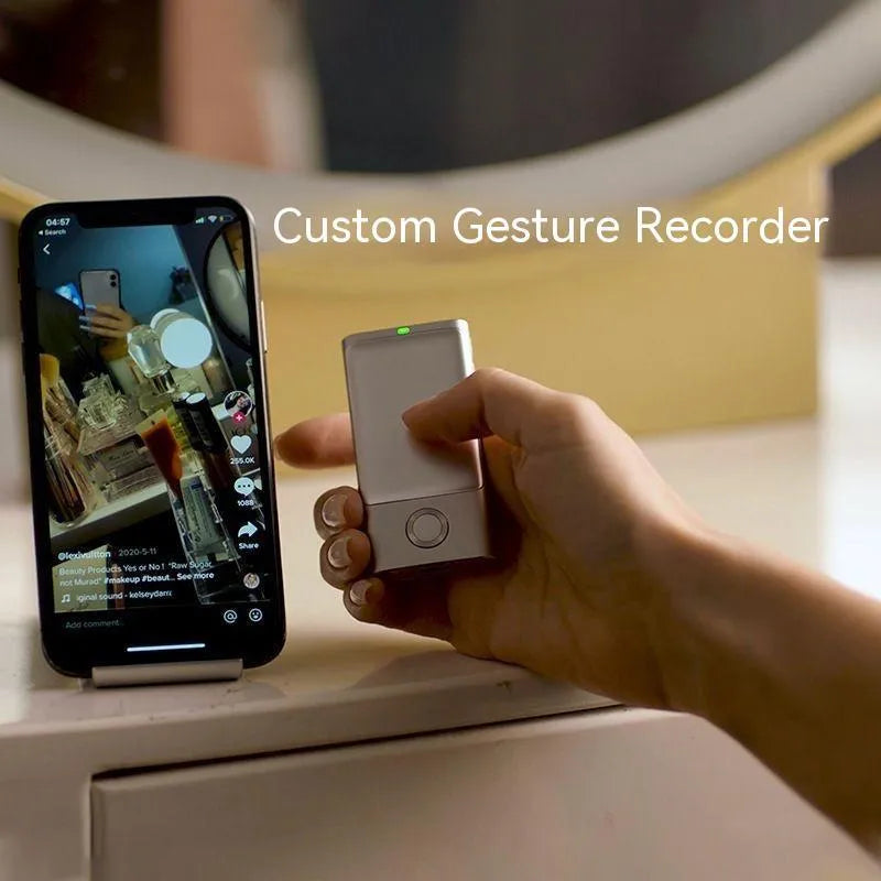 Silver wireless presenter with laser pointer and remote control on table