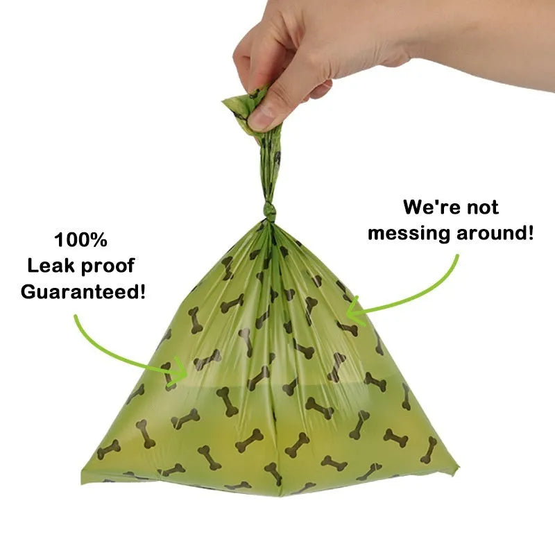 Roll of army green degradable dog poop bags with black bone print, showing bag size scale