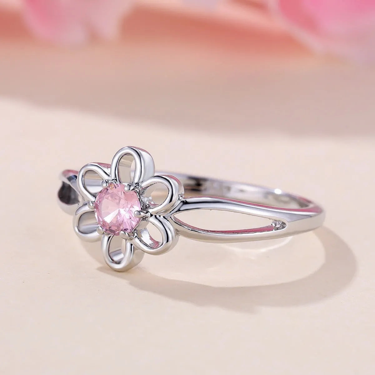 Women's hollow floral fashion ring in copper with electroplated finish, shown in platinum pink diamond colour.