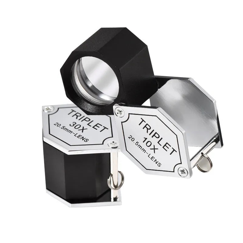 Handheld metal magnifying glass with optical glass lens for jewellery and stamp inspection.