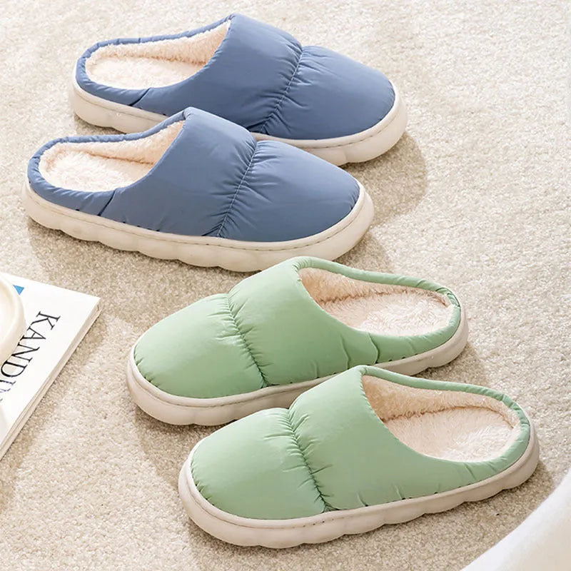 Blue winter slippers for indoor use with a thick rubber non-slip sole and artificial plush lining.