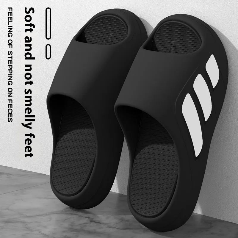 Men's and women's brown EVA platform slippers with a letter detail on the upper, shown on a white background.