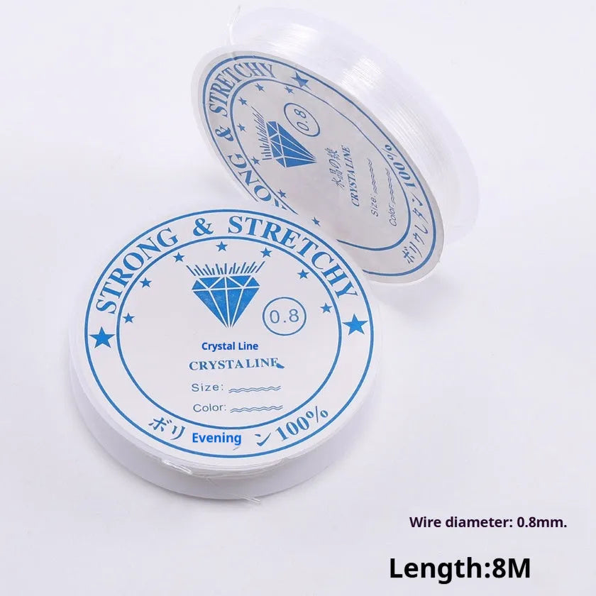 Transparent white elastic fishing line on a roll for DIY jewellery and craft ornaments.